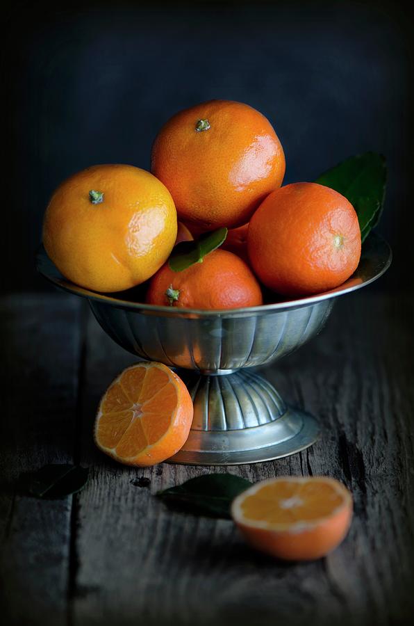 Fresh Clementines In A Metal Bowl On A Wooden Surface Photograph by ...