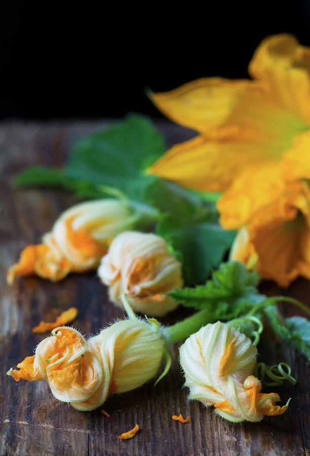 Fresh Courgette Flowers On A Wooden Table Photograph by Joanna Lewicka