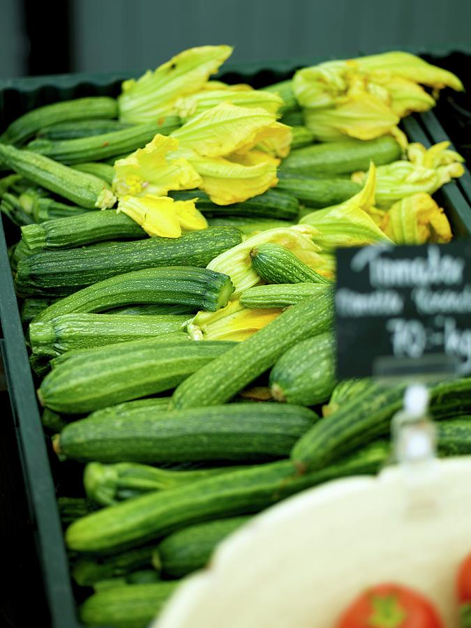 Fresh Courgettes, Some With Flowers, In A Crate On A Market Stall Photograph by Lina Eriksson