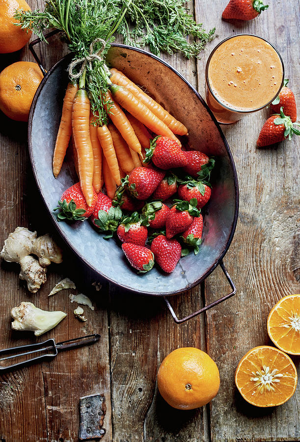 Fresh Detox Juice With Oranges, Strawberries, Ginger And Carrots Photograph by Fred + Elliott  Photography