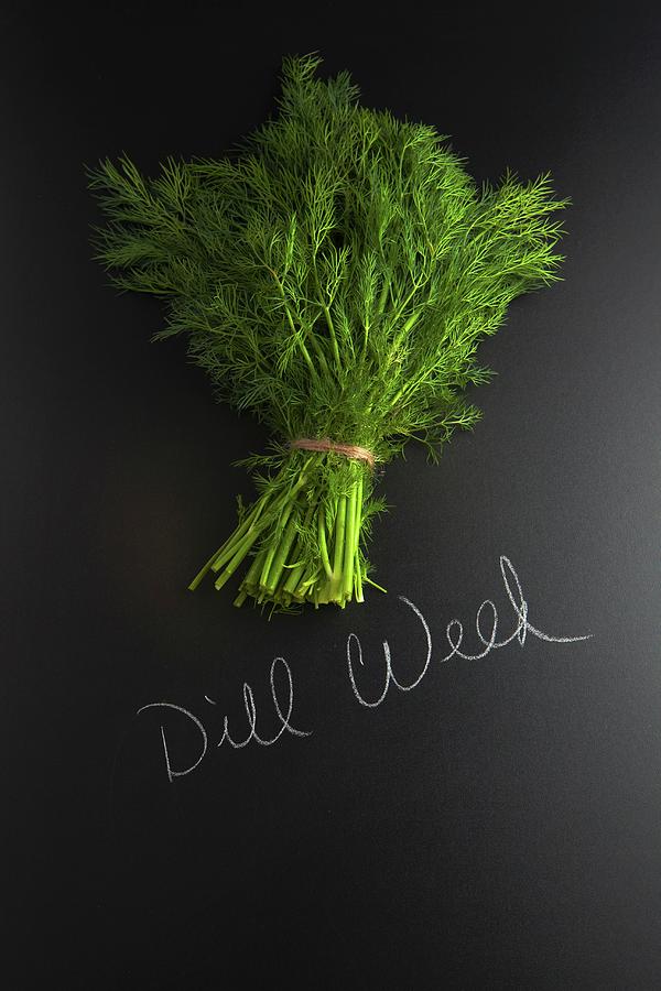Fresh Dill On A Slate Surface With A Label Photograph by Vfoodphotography