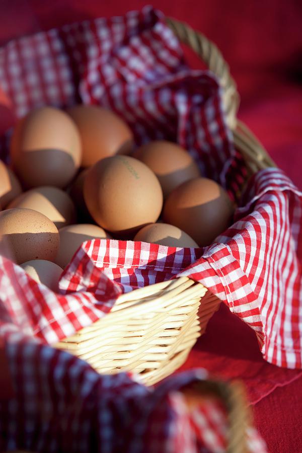 Fresh Eggs In A Basket Lined With A Checked Cloth Photograph by Joerg Lehmann
