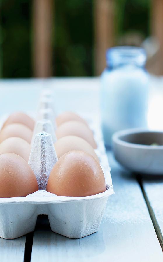 Fresh Eggs In A Carton On An Outdoor Table Photograph by Strokin, Yelena