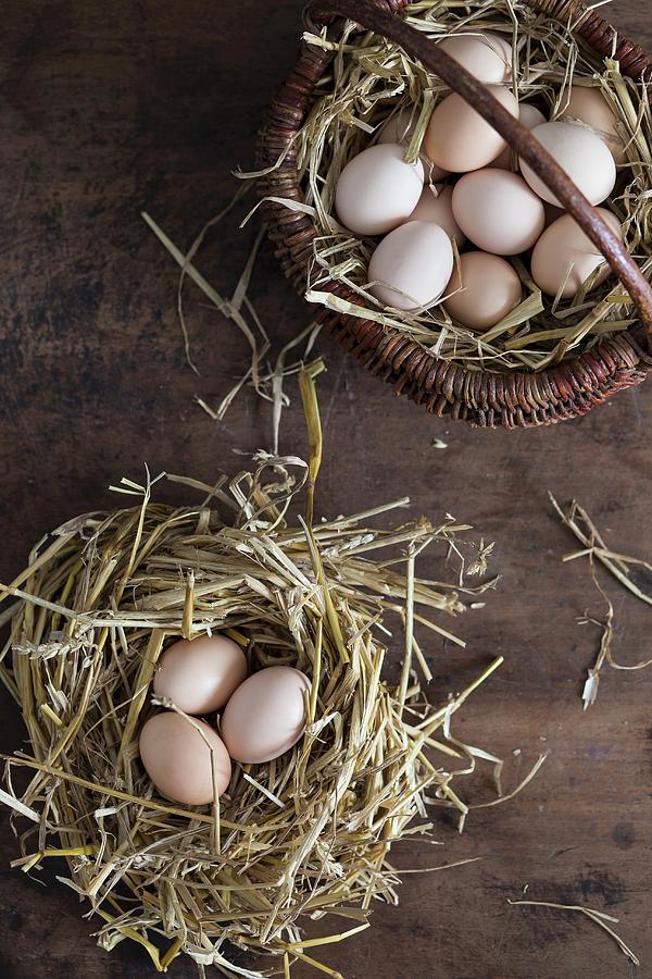 Fresh Eggs In A Straw Nest And In A Basket Photograph by Malgorzata Laniak