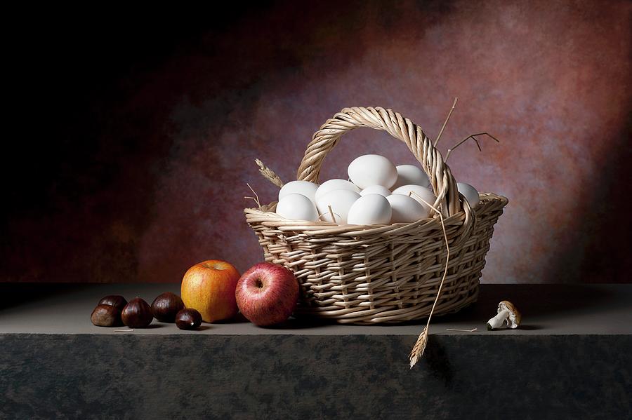Fresh Eggs In A Wicker Basket With Apples, Chestnuts And Mushrooms Photograph by Elio Lombardo