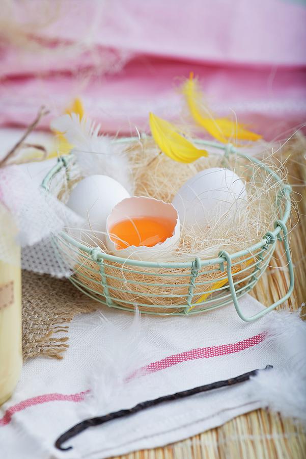 Fresh Eggs With Feathers In A Wire Basket Photograph by Dorota Indycka