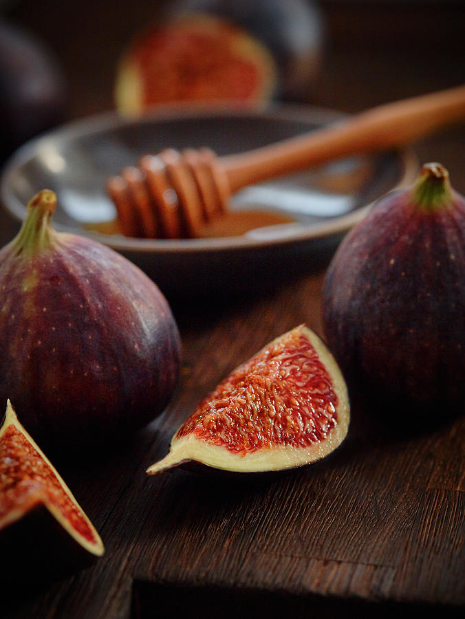 Fresh Figs And A Honey Dipper On A Dark Wooden Background Photograph by Dominik Paunetto