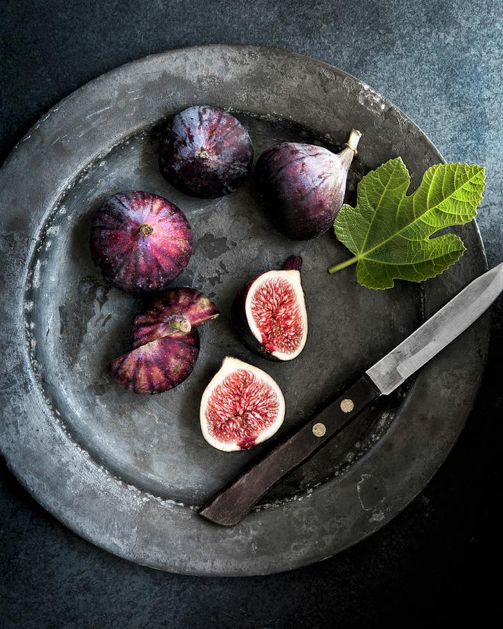 Fresh Figs On A Metal Plate With A Knife And A Fig Leaf seen From Above Photograph by Magdalena Hendey