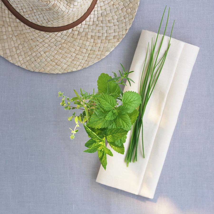 Fresh Garden Herbs With A Napkin And A Straw Hat Photograph by Feig & Feig