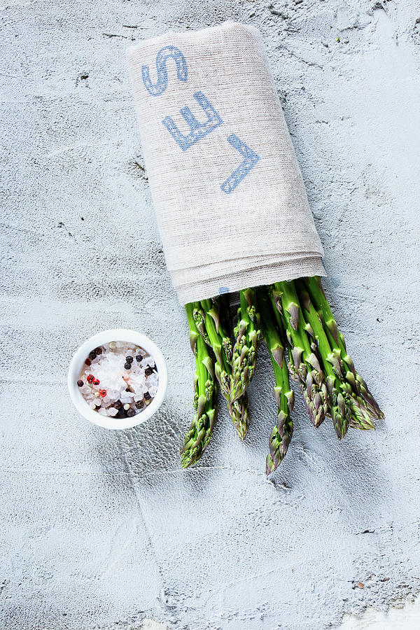 Fresh Green Asparagus Wrapped In A Cloth, With A Bowl Of Spices Photograph by Yuliya Gontar