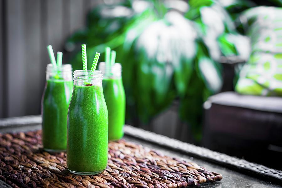Fresh Green Smoothie In Glass Bottles With Straws Photograph by Alena Haurylik