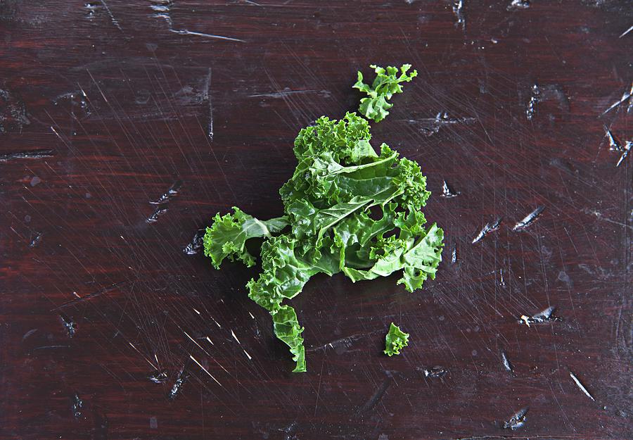 Fresh Kale On A Wooden Surface Photograph by Richard Church