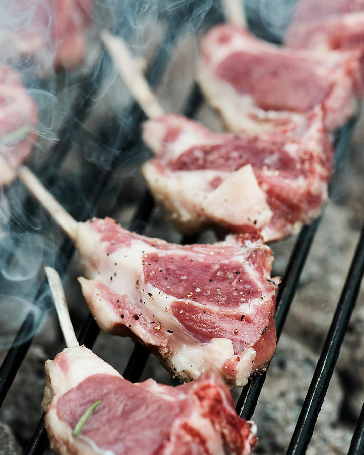 Fresh Lamb Racks Layed On A Barbecue To Cook Photograph by Miha Lorencak