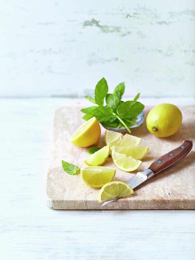 Fresh Mint And Lemon, Whole And Cut Into Wedges Photograph by B.&.e.dudzinski