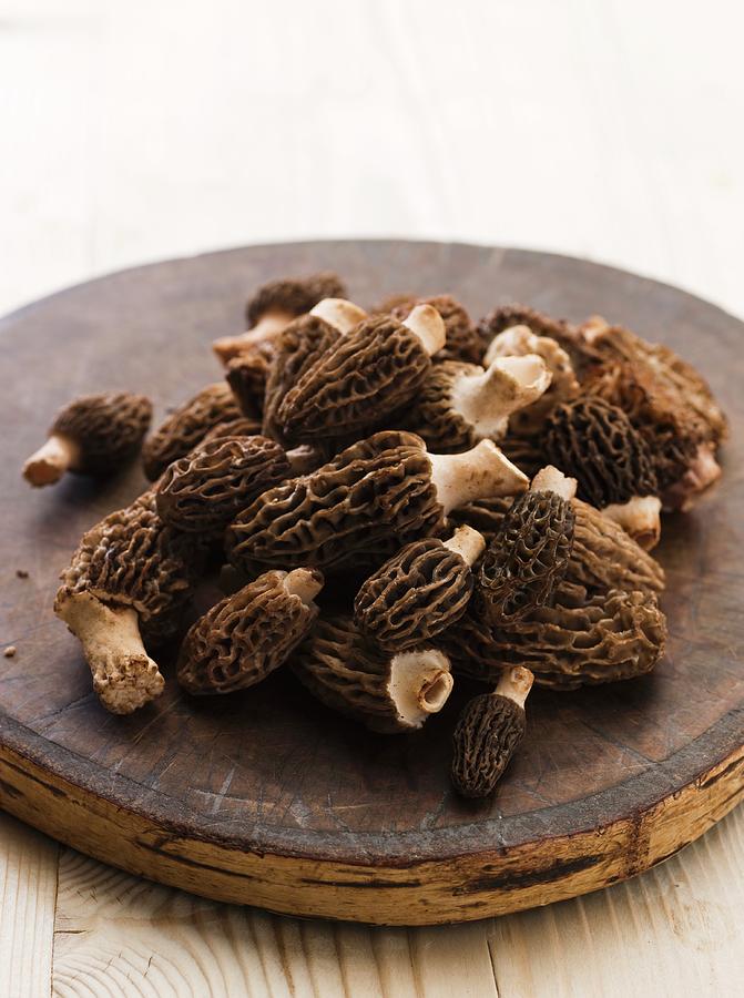 Mushroom Photograph - Fresh Morels On A Round Wooden Board by Lingwood, William
