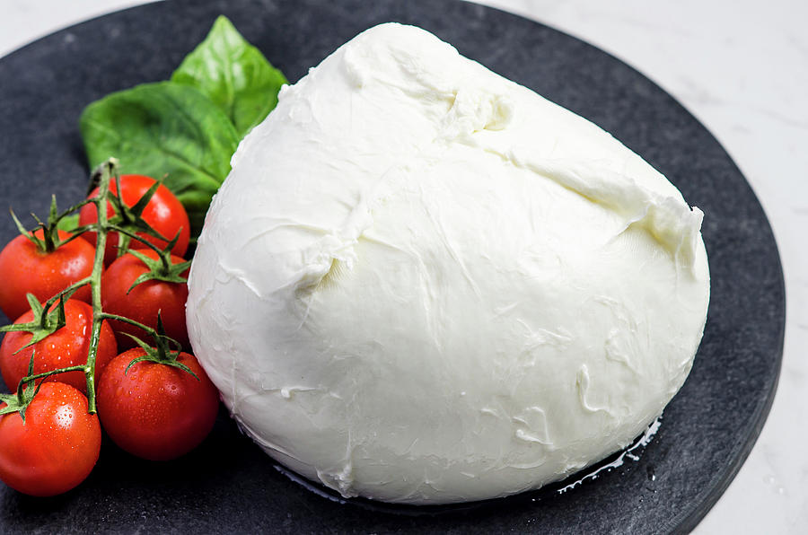 Fresh Mozzarella Garnished With Cherry Tomatoes And Basil Leaves On A Dark Stone Plate Photograph by Giulia Verdinelli Photography