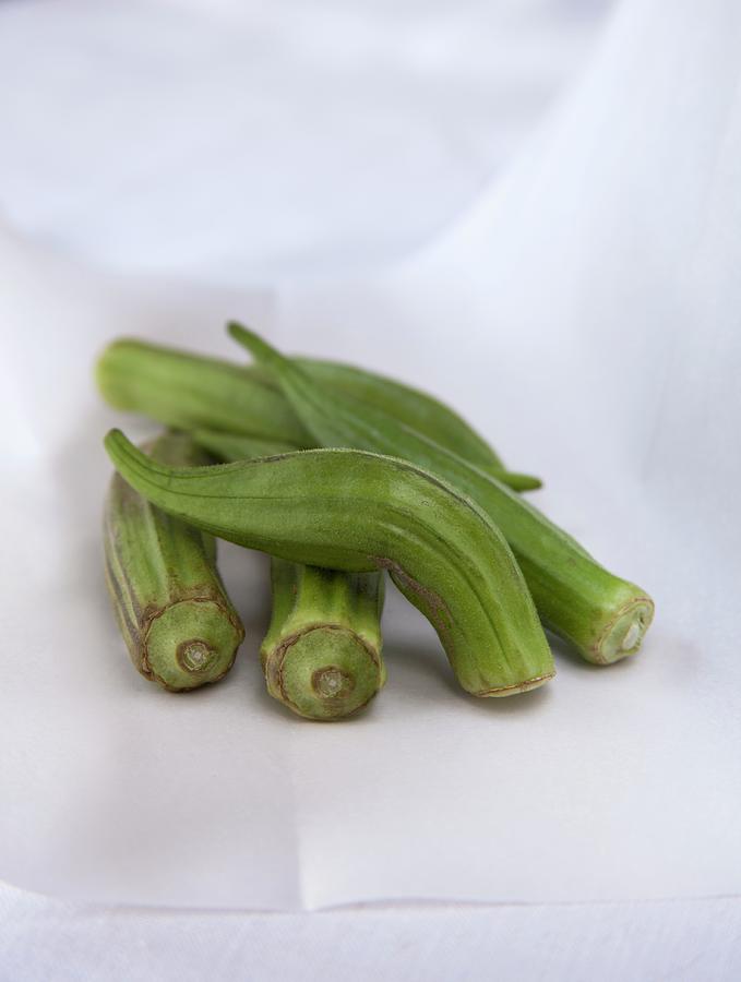Fresh Okra Pods On White Parchment Paper Photograph by Katharine Pollak