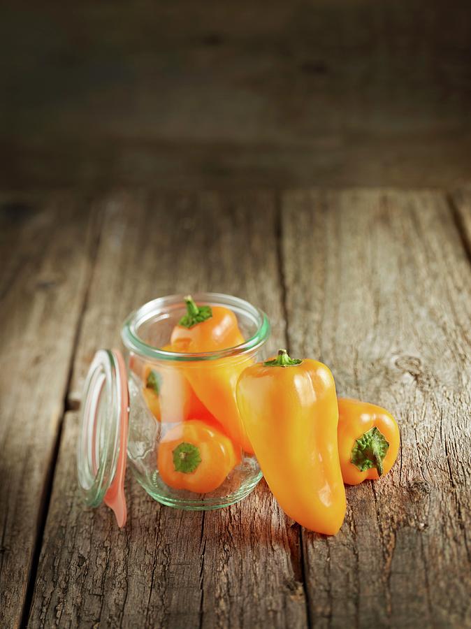 Fresh Orange Pepper In And Next To A Preserving Jar Photograph by Michael Lffler