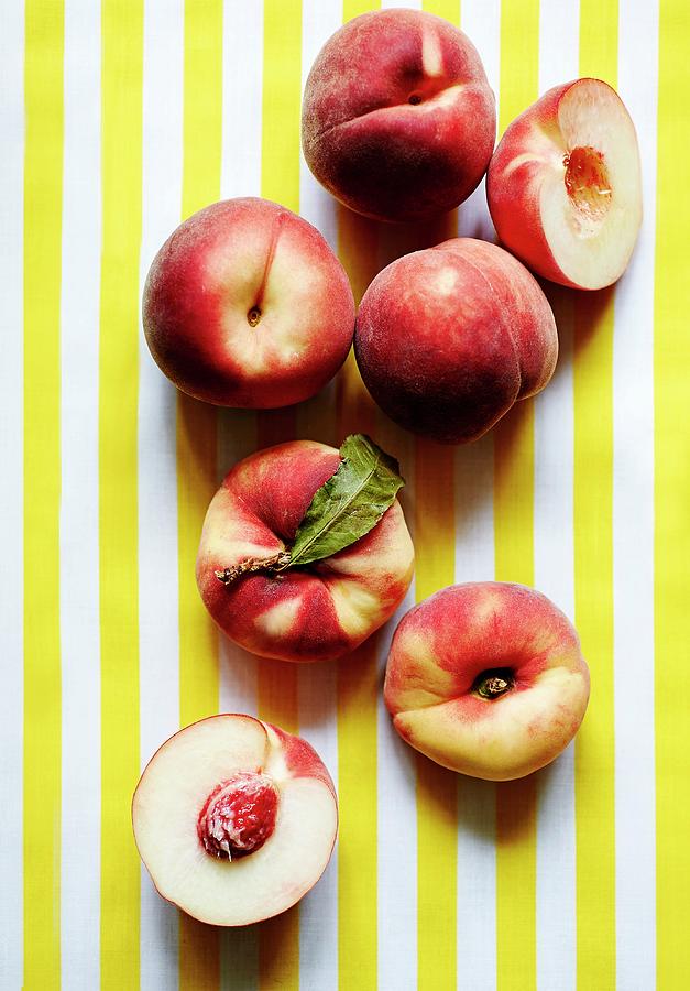 Fresh Peaches, Whole And Halved Photograph by Ria Osborne