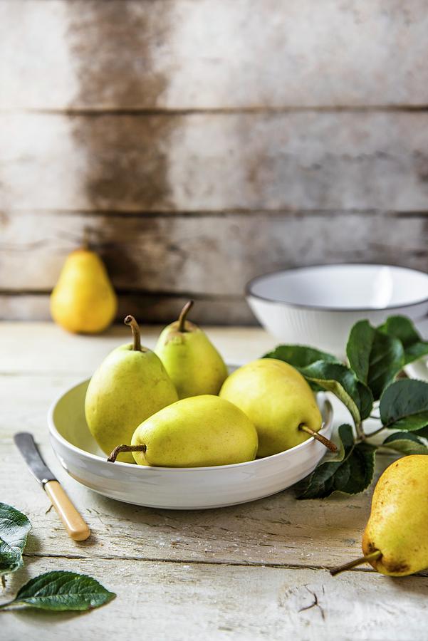 Fresh Pears In A Bowl On A Wooden Table Photograph by Magdalena Hendey