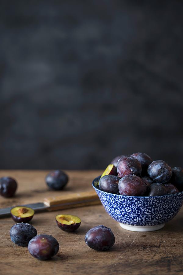 Fresh Plums In A Ceramic Bowl And Next To It Photograph by Malgorzata Laniak