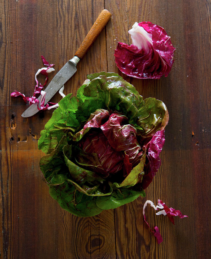 Fresh Radicchio Salad With A Kitchen Knife On A Wooden Surface Photograph by Udo Einenkel