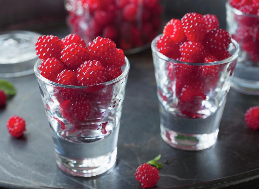 Fresh Raspberries In Shot Glasses Photograph by Katharine Pollak