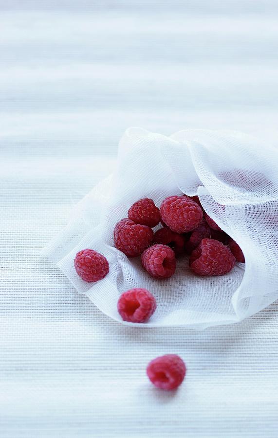 Fresh Raspberries On A Piece Of White Fabric Photograph by Vivi Dangelo