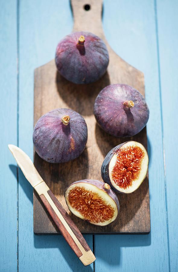 Fresh Red Figs On A Chopping Board, One Cut In Half Photograph by Komar