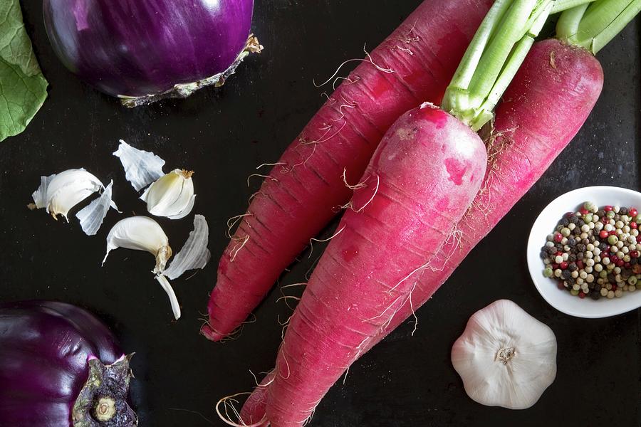 Fresh Red Radishes, Garlic, Aubergines And Peppercorns Photograph by Catja Vedder