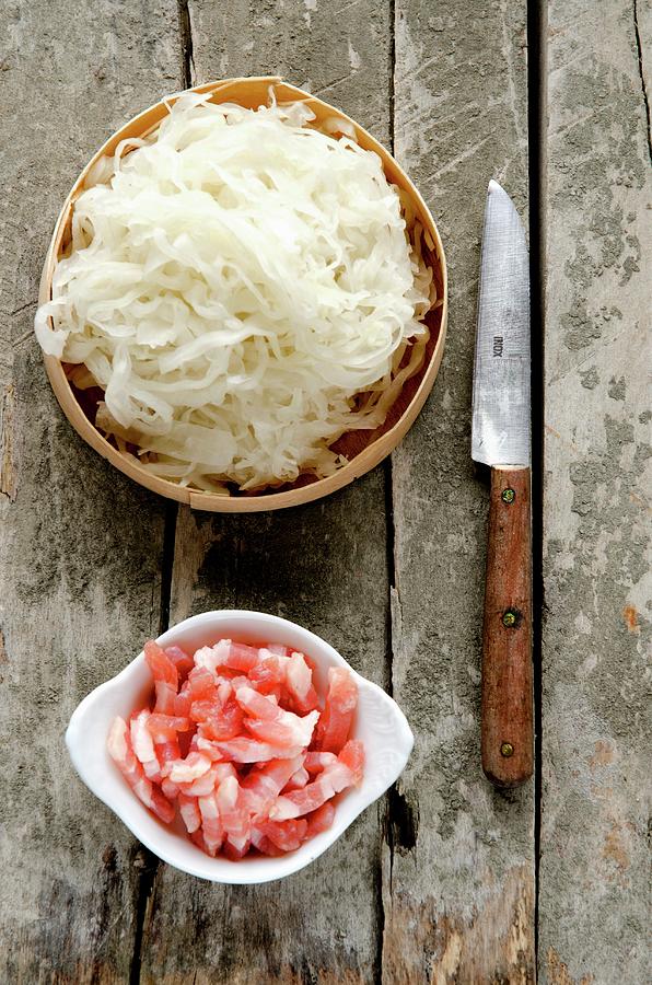Fresh Sauerkraut From Alsace In A Wooden Dish, Lardons Of Bacon And A Rustic Knife Photograph by Jamie Watson