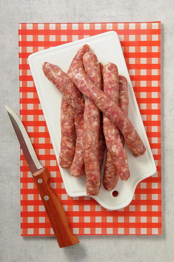 Fresh Sausages On A Chopping Board Photograph by Jean-christophe Riou
