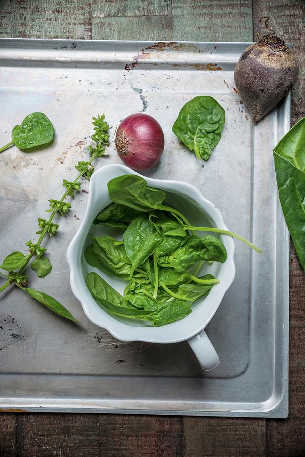 Fresh Spinach In A Porcelain Bowl On A Baking Tray And On A Wooden Surface, Beetroot, Basil, Red Onions And Chard Photograph by Angelika Grossmann
