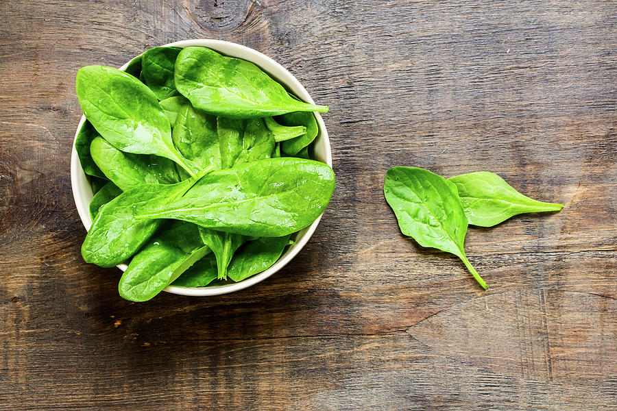 Fresh Spinach Leaves In A Bowl On A Wooden Background top View Photograph by Yuliya Gontar