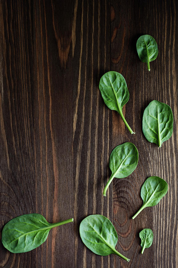 Fresh Spinach Leaves On Wooden Background Photograph by Mateusz Siuta