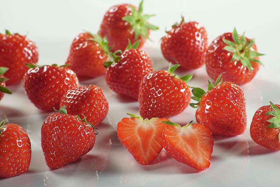 Fresh Strawberries, Whole And Halved Photograph by Brigitte Wegner