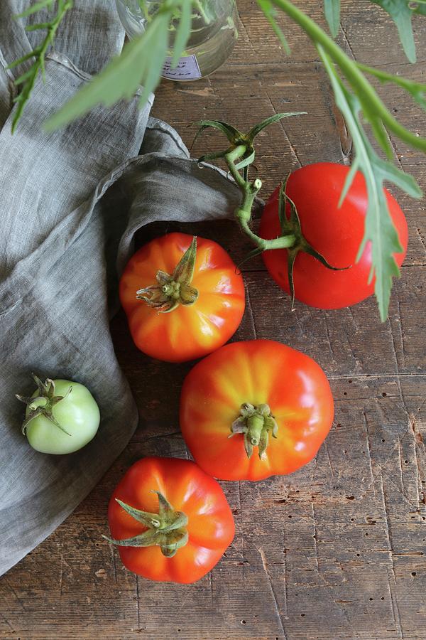 Fresh Tomatoes On A Rustic Wooden Table Photograph by Regina Hippel
