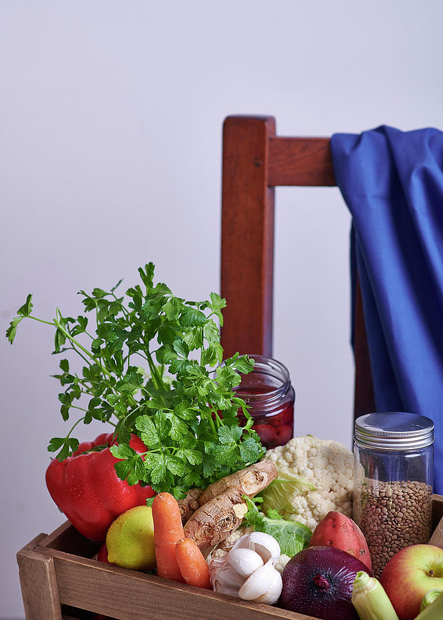 Fresh Vegetables, Fruit And Herbs In A Wooden Crate On A Chair Photograph by Great Stock!