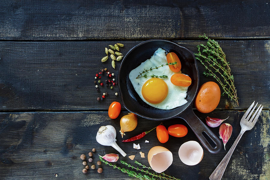 Fresh Vegetables With Fried Eggs On Dark Wooden Background With Space For Text Photograph by Yuliya Gontar