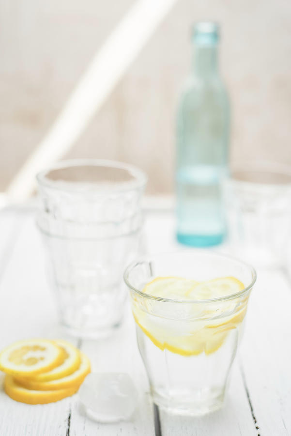 Fresh Water In A Glass With Ice Cubes And Lemon Slices Photograph by Canan Czemmel