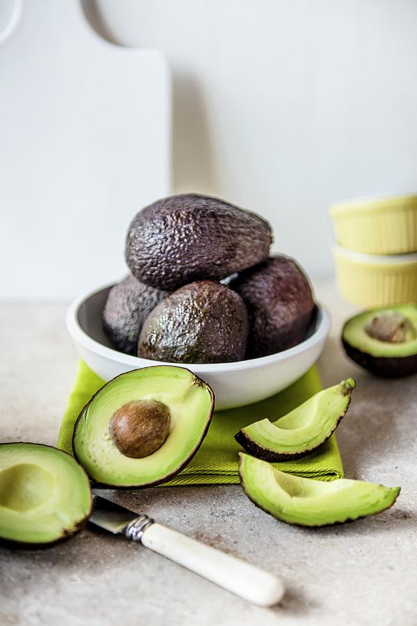 Fresh Whole And Sliced Avocados Photograph by Magdalena Hendey
