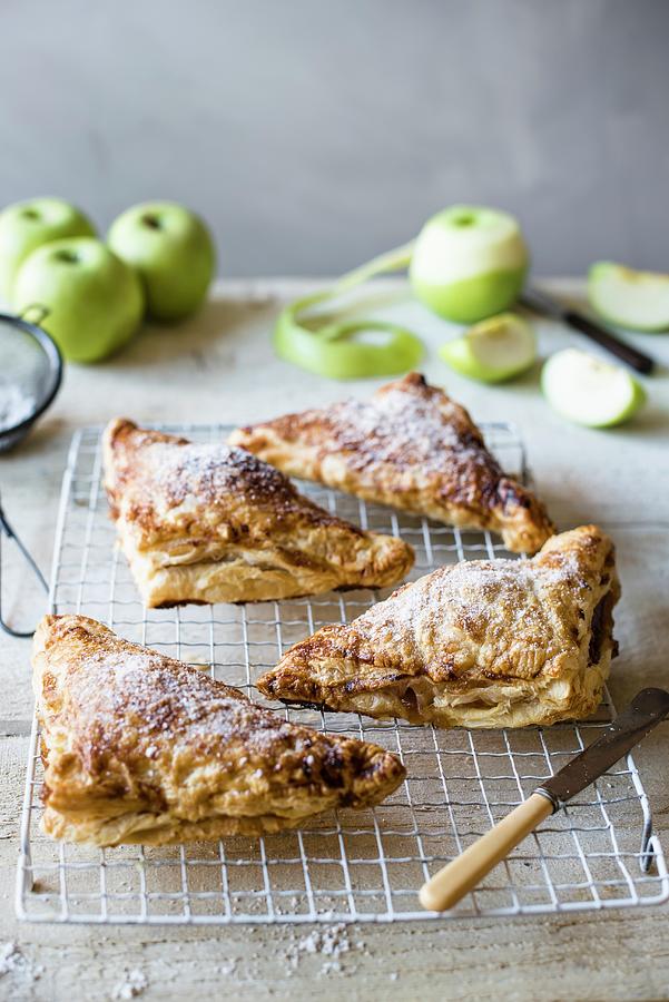 Freshly Baked Apple Turnovers On A Cooling Tray Photograph by Magdalena Hendey