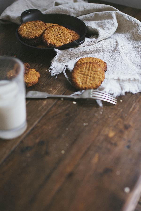 Freshly Baked Cookies And Milk On A Wooden Table Photograph by Tanya Balianytsia