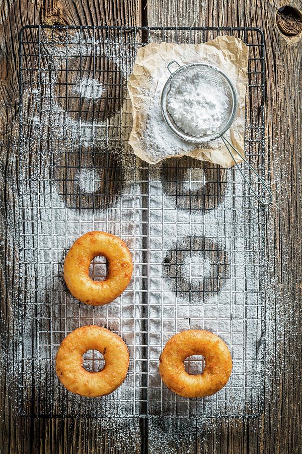 Freshly Baked Doughnuts With Icing Sugar Photograph by Shaiith