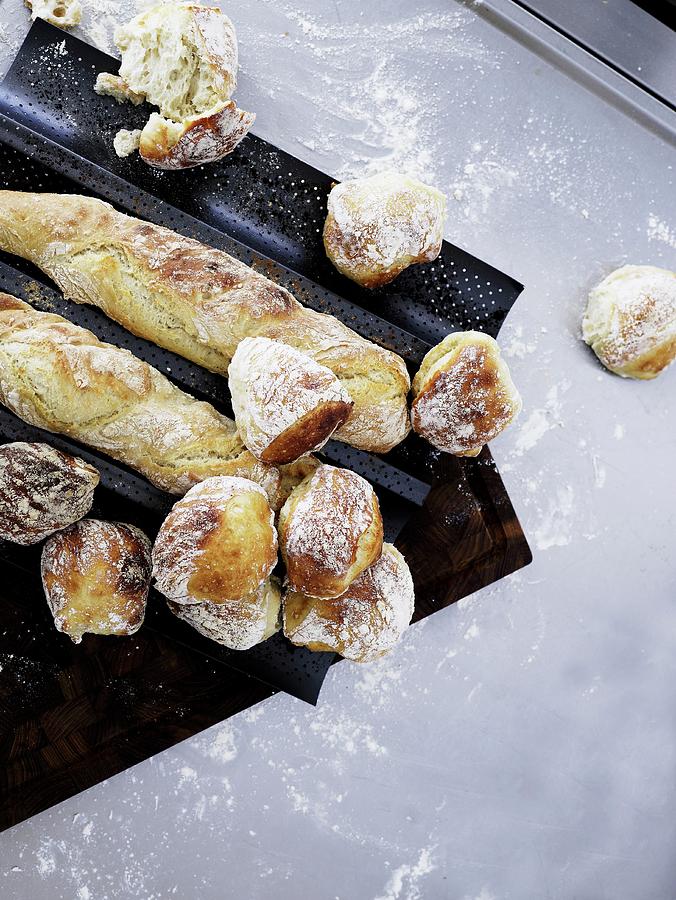 Freshly Baked Rolls And Baguettes On A Baguette Baking Tray Photograph by Mikkel Adsbl