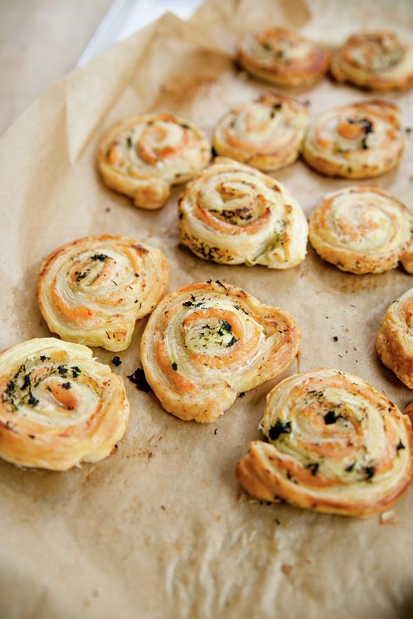 Freshly Baked Salmon Puff Pastry Swirls On A Baking Sheet Photograph by Claudia Timmann