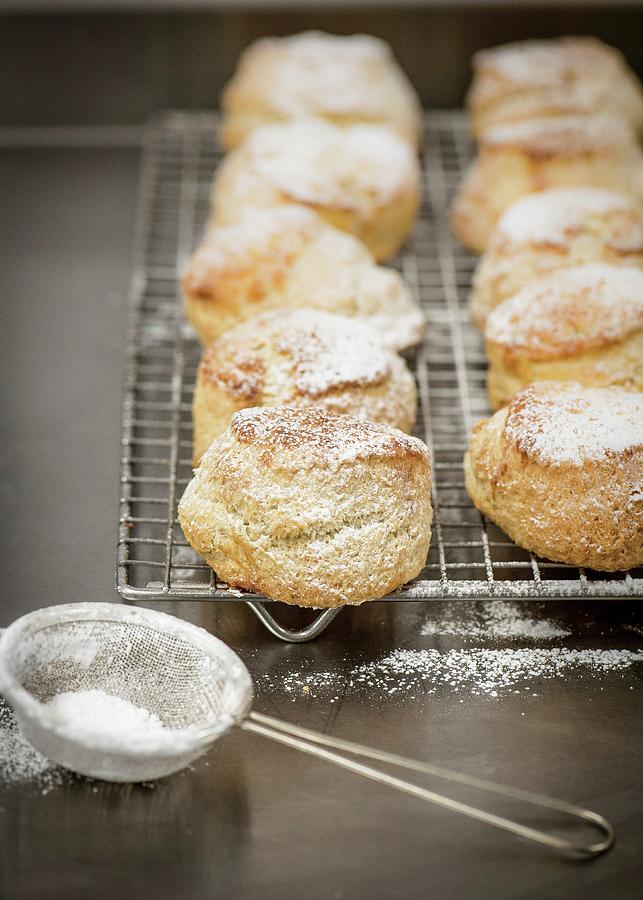 Freshly Baked Scones Dusted With Icing Sugar On A Cooling Rack Photograph by Magdalena Hendey
