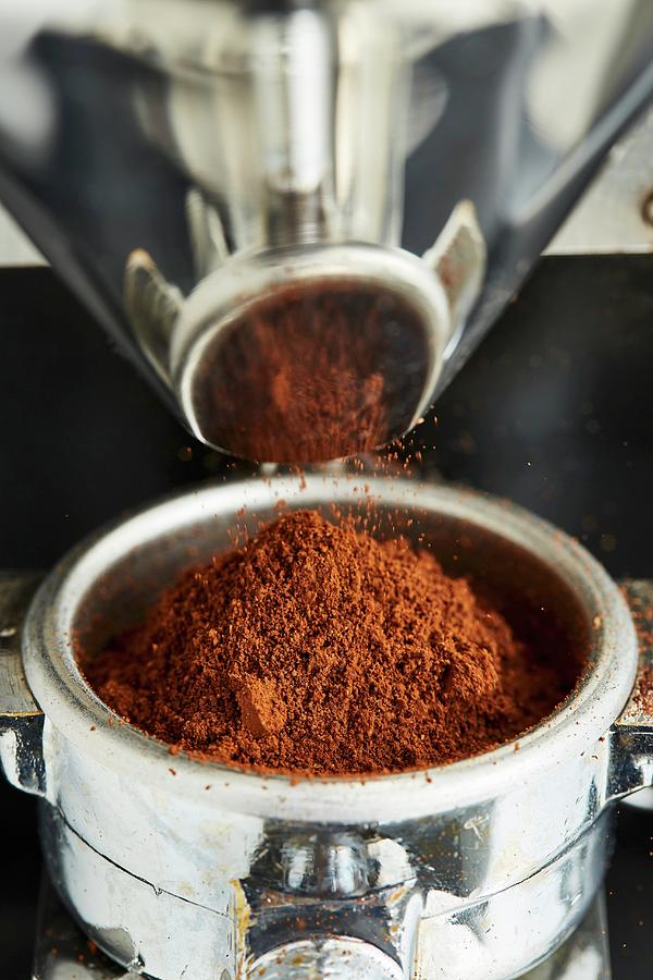 Freshly Ground Coffee Falls From A Coffee Mill Into A Filter Holder Photograph by Herbert Lehmann