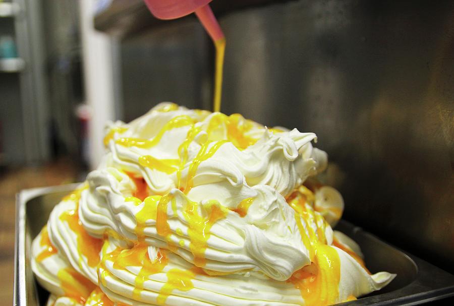 Freshly Made Vanilla Ice Cream Being Drizzled With Mango And Passion Fruit Sauce Photograph by Vivi Dangelo
