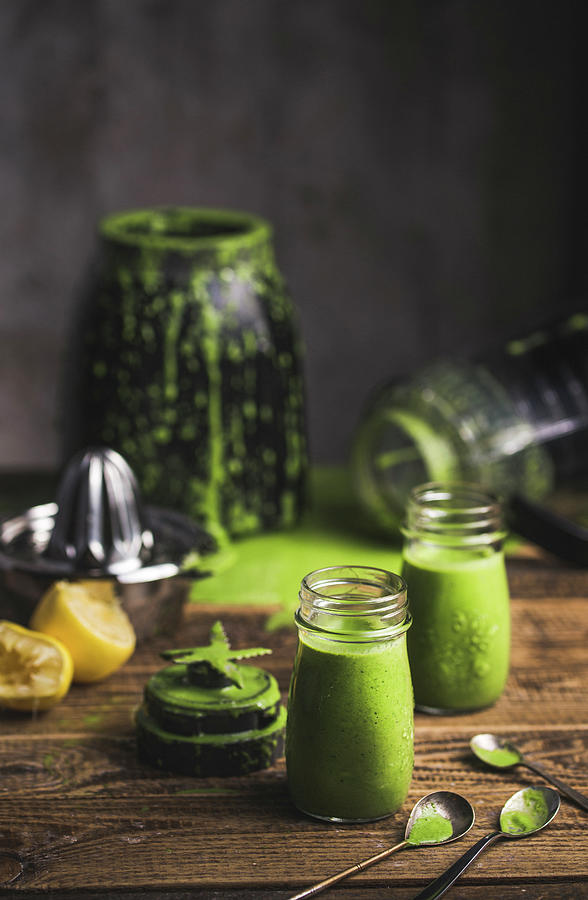 Freshly Mixed Green Smoothies In Screw-top Jars With A Blender In A Background Photograph by Karolina Kosowicz